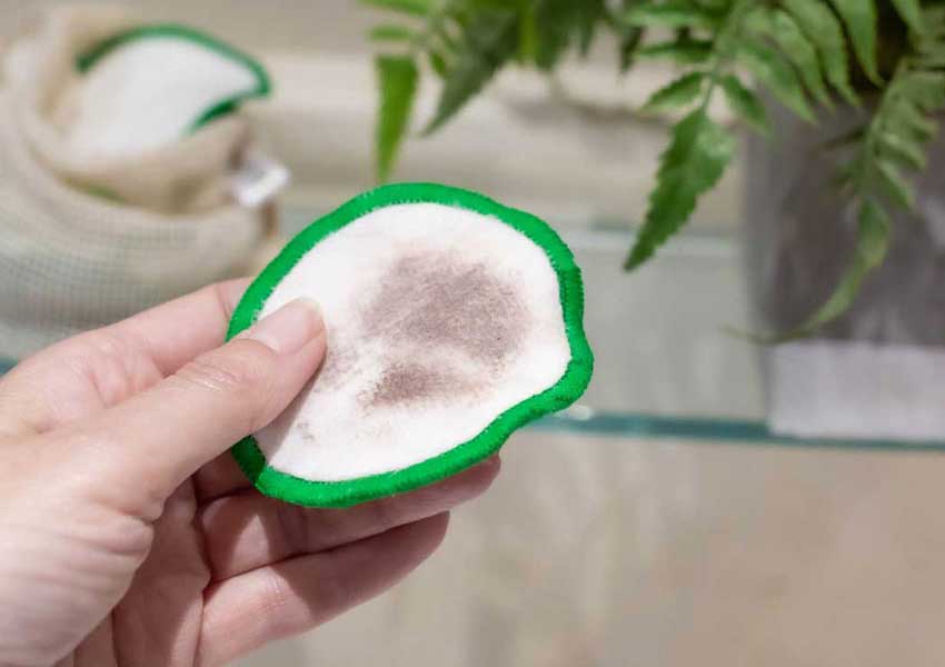 Reusable bamboo makeup remover pads showing make-up that has been removed 